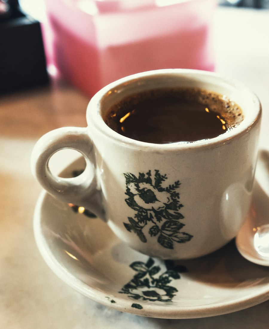 Kopi in a white cup with a green floral pattern, kopitiam style